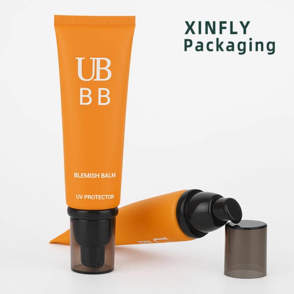 Orange PE cosmetic airless pump tube with clear cap for sunscreen and lotion